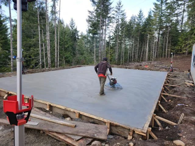 Concrete patio installation in Calgary with professional slab pouring and power trowel finishing