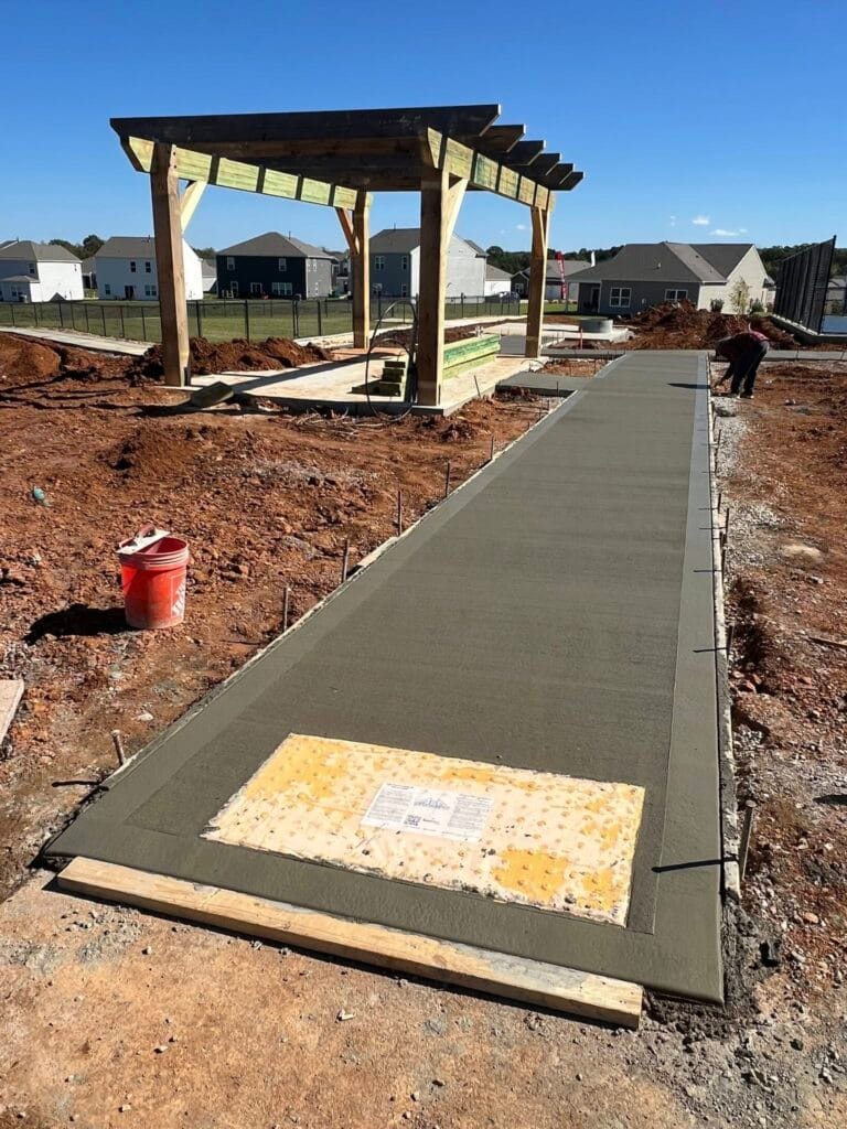 Concrete walkway installation with proper formwork, grading, and finishing preparation