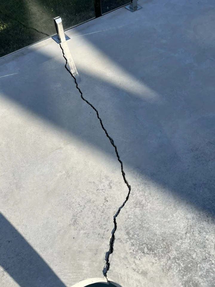 Cracked concrete sidewalk in Calgary caused by freeze-thaw cycles