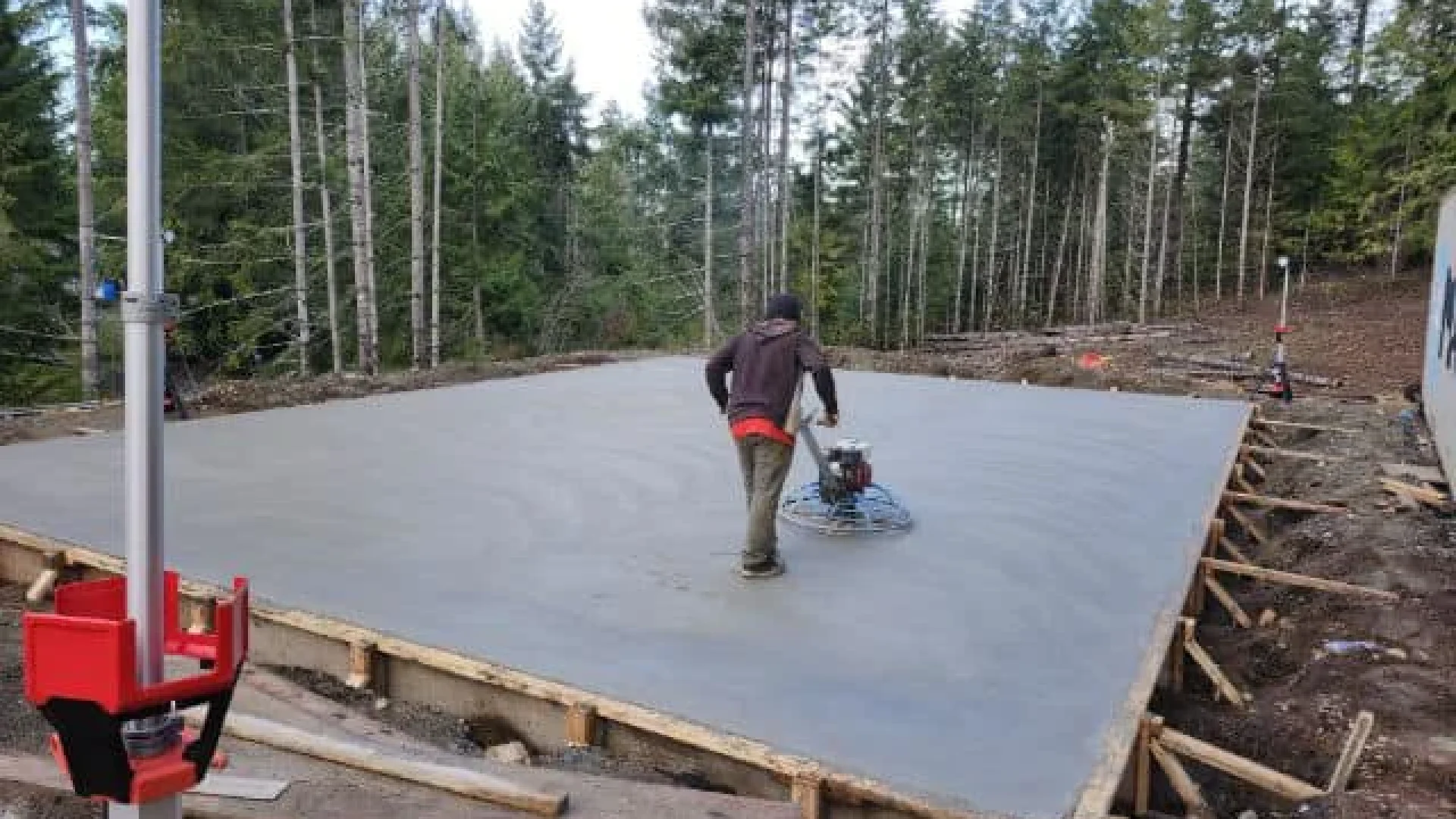 Concrete patio installation in Calgary with professional slab pouring and power trowel finishing