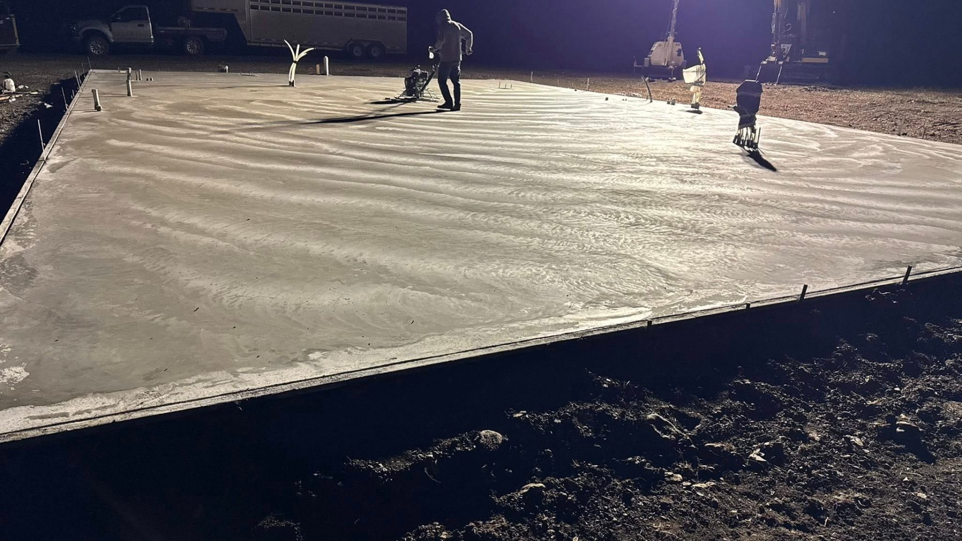 Concrete slab pour at night with proper lighting, crew coordination, and site preparation