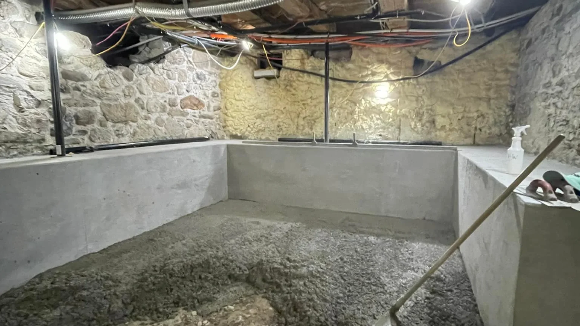 Basement concrete floor installation inside existing foundation with moisture control